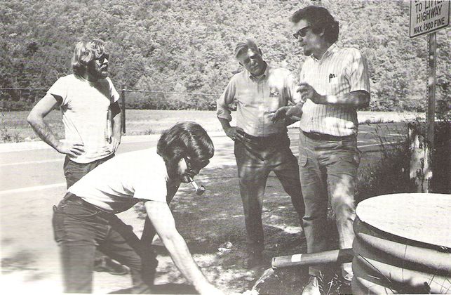 John Renton speaking with three others in the late 1970s