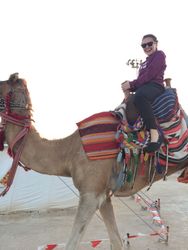 Emma Harrison riding a camel 