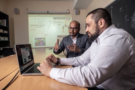 Subhasish Mandal, WVU assistant professor in condensed matter physics, works with graduate student Christopher Jacobs. 