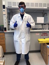 Tyler Davidson in the lab wearing PPE